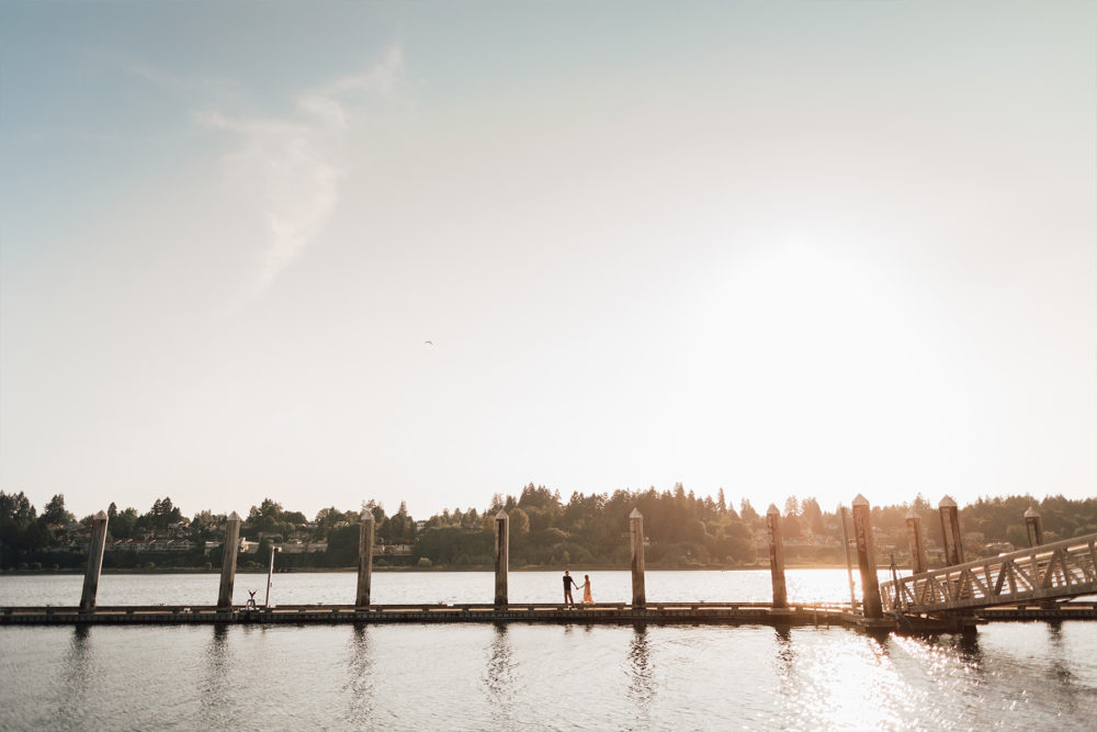 Young couple holding hands at Percivals Landing in Olympia WA