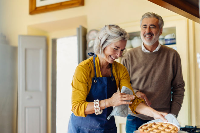 Older couple cooking in kitchen