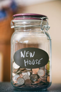 Jar of change that reads New House