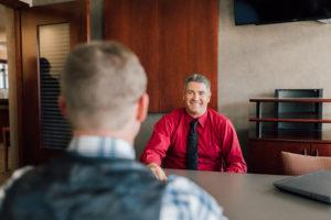 Cetera Financial Advisor Jason Andrew sitting at desk with customer.